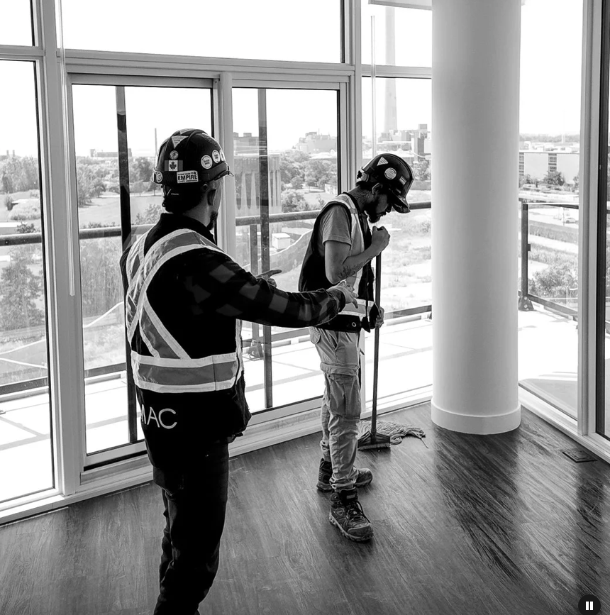 LEMAC team cleaning floor-to-ceiling windows in a high-rise condo